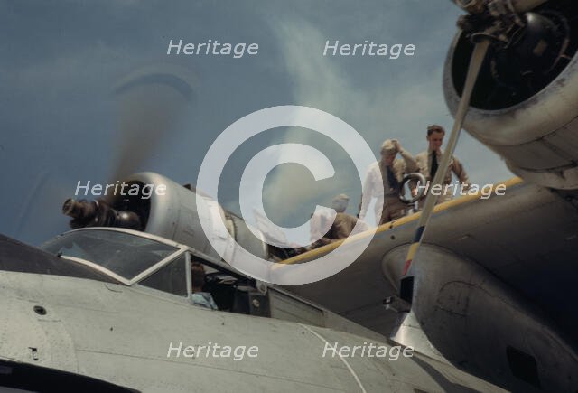 Starting a propeller at the Naval Air Base, Corpus Christi, Texas, 1942. Creator: Howard Hollem.