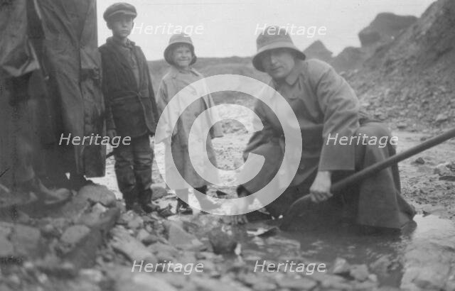 Mr. Lindeberg panning gold at Pioneer Mine with a shovel, between c1900 and 1916. Creator: Unknown.