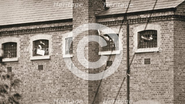 Hunger strikers waving to Christabel Pankhurst from their cells in Holloway Prison, London, 1909. Artist: Unknown