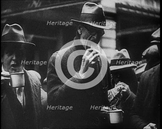 Three Men in the Foreground Drinking and Eating, 1933. Creator: British Pathe Ltd.