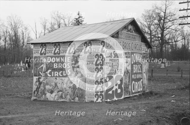 Posters covering a building near Lynchburg to advertise a Downie Bros. circus, 1936. Creator: Walker Evans.