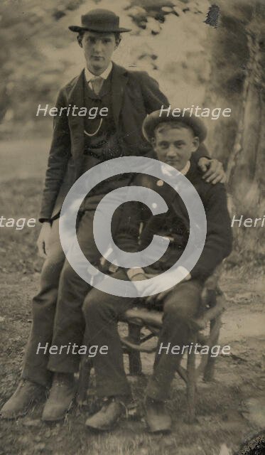 Two Young Men Outdoors, One Seated, the Other on the Arm of the Chair, 1880s. Creator: Unknown.