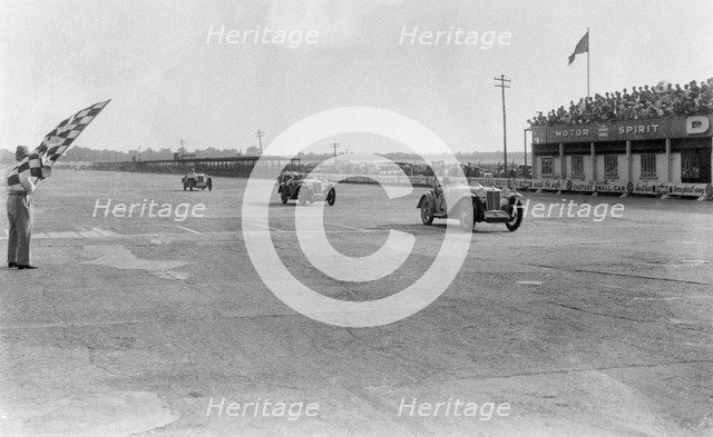MG Magna of SG Cummings winning a race, BARC meeting, Brooklands, Surrey, 1933. Artist: Bill Brunell.
