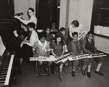 Music classes, keyboards and piano, 1938. Creator: Aubrey Pollard.