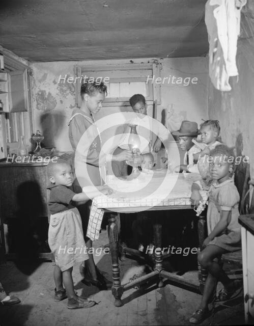 A family which lives in the Southwest area, Washington, D.C., 1942. Creator: Gordon Parks.