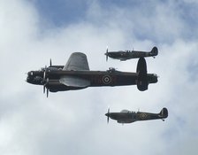 2011 Goodwood Revival Meeting, Lancaster bomber and 2 Spitfires in aerial display. Artist: Unknown.