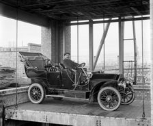 A car and chauffeur in the car lift at Mitchell's Motors, Wardour Street, London, 1907. Artist: Bedford Lemere and Company