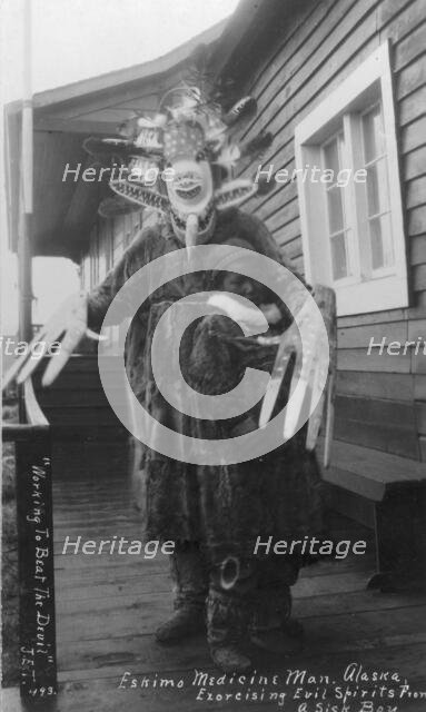 Eskimo medicine man and sick boy, between c1900 and c1930. Creator: Unknown.