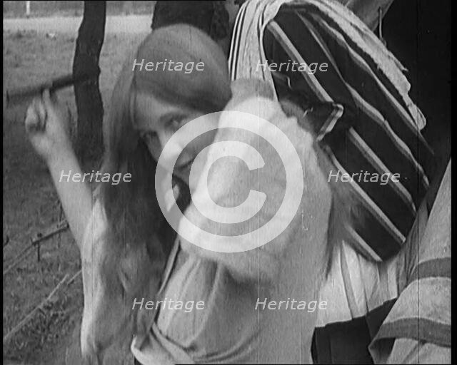 Female Civilian Brushing Her Long Hair Outdoors, 1920. Creator: British Pathe Ltd.