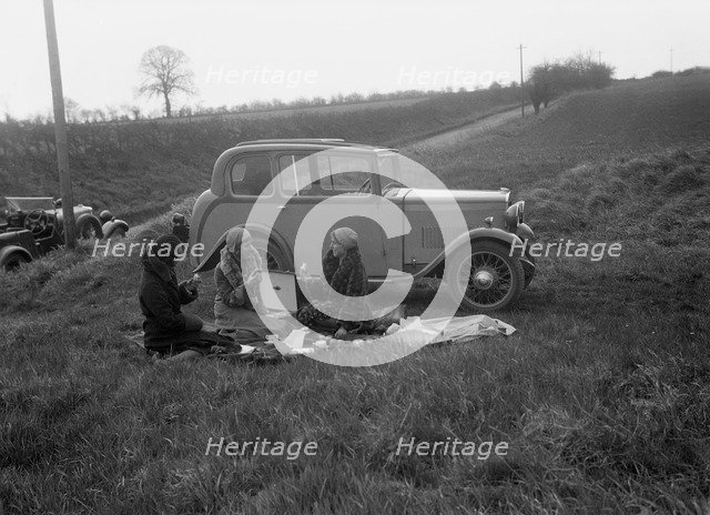 Three women having a picnic during a road test of a Triumph Scorpion, 1931. Artist: Bill Brunell.
