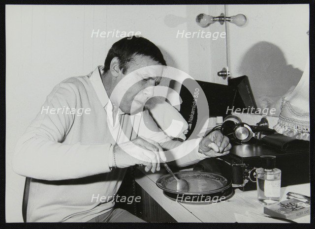 Buddy Rich eating backstage at Ronnie Scott's Jazz Club, London, 1979. Artist: Denis Williams