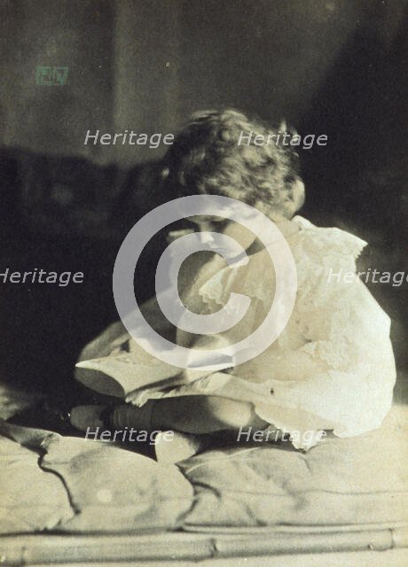 Girl sitting with legs folded, reading a book, c1900. Creator: Eva Watson-Schutze.