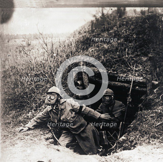 Soldiers in gas masks emerging from trenches, c1914-c1918. Artist: Unknown.