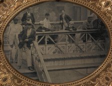 Group of Men and Boys Standing Along the Railing of the Fulton Street Bridge, 1866-68. Creator: Unknown.