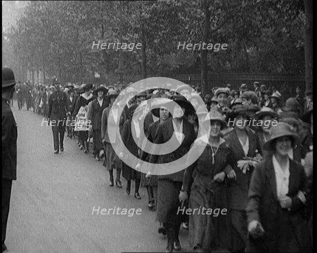 Striking Tea Shop Ladies Marching Down the Road, Flanked by Police, 1920. Creator: British Pathe Ltd.