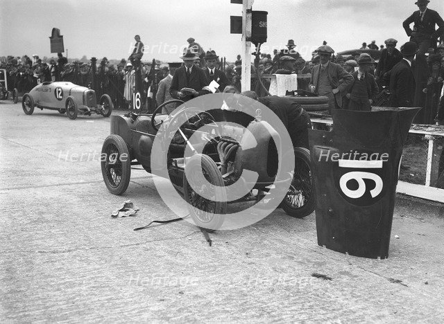 Leon Cushman working on his Bugatti Brescia at the JCC 200 Mile Race, Brooklands, Surrey, 1922. Artist: Bill Brunell.