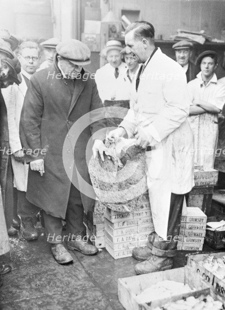 Man choosing fish at Billingsgate Market, London, (c1930s?). Artist: Unknown