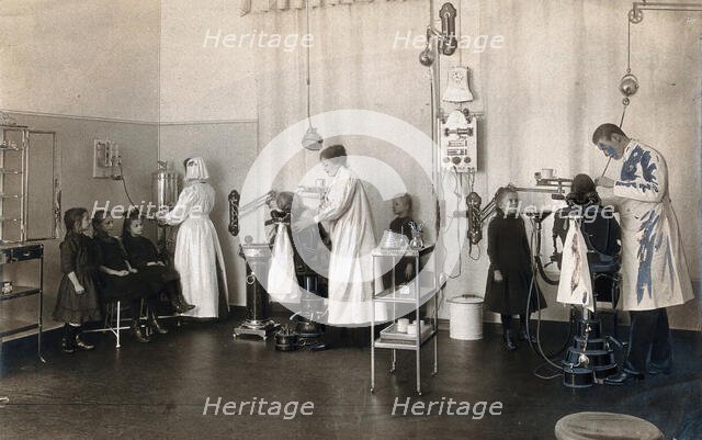 A school-children's dental clinic in Berlin: some children being treated..., c1900. Creator: Unknown.