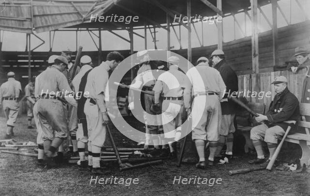 Cleveland [AL] ball players selecting new bats; Graney on bench, 1910. Creator: Bain News Service.