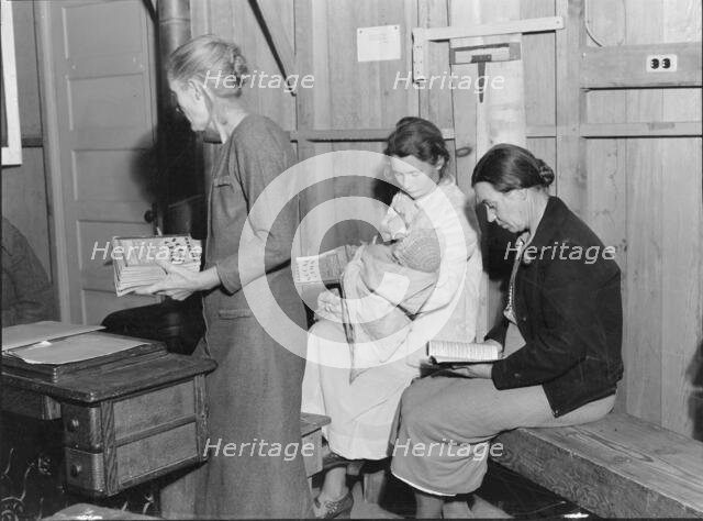 Hymn singing at meeting of Mothers' Club in Arvin migrant camp, California, 1938. Creator: Dorothea Lange.