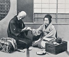 A Japanese doctor and patient, 1902. Artist: Kajima & Suwo.