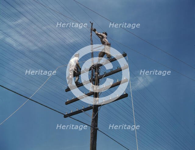 Men working on telephone lines, probably near a TVA dam hydroelectric plant, 1942. Creator: Alfred T Palmer.