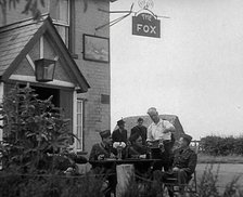 American Airmen Drinking Outside a Public House in England, and Being Served by the..., 1943-1944. Creator: British Pathe Ltd.