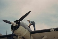 Sailor mechanic fueling a plane at the Naval Air Base, Corpus Christi, Texas, 1942. Creator: Howard Hollem.