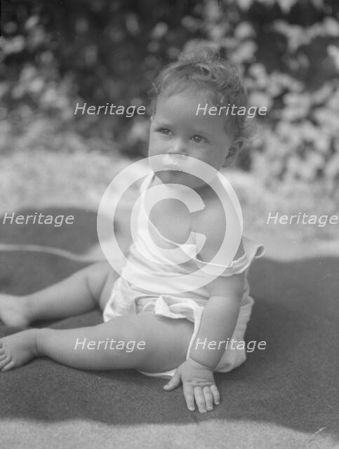 Nadelman baby, seated outdoors, 1923 July 12. Creator: Arnold Genthe.