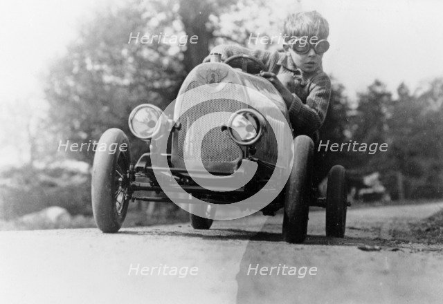 Boy in a pedal car. Artist: Unknown