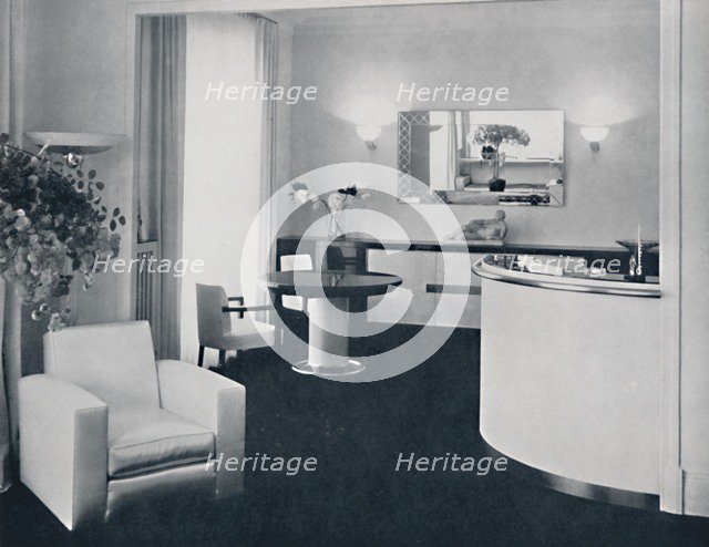 'Jacques Adnet - Bar corner of a dining-room. The furniture is in polished black pearwood, black gla Artist: A. Salaun.