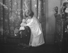 Rice, Isaac, Mrs., grandaughter of, playing with a doll, 1920 May 27. Creator: Arnold Genthe.