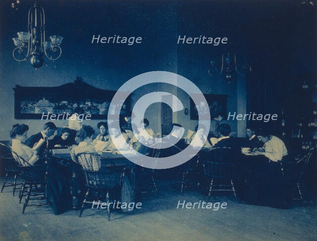 Students seated around tables, studying, at Western High School, Washington, D.C., (1899?). Creator: Frances Benjamin Johnston.