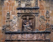 Front door of St. Peter's Cathedral, crowned by the seated image of Saint Peter Pope, embedded in…