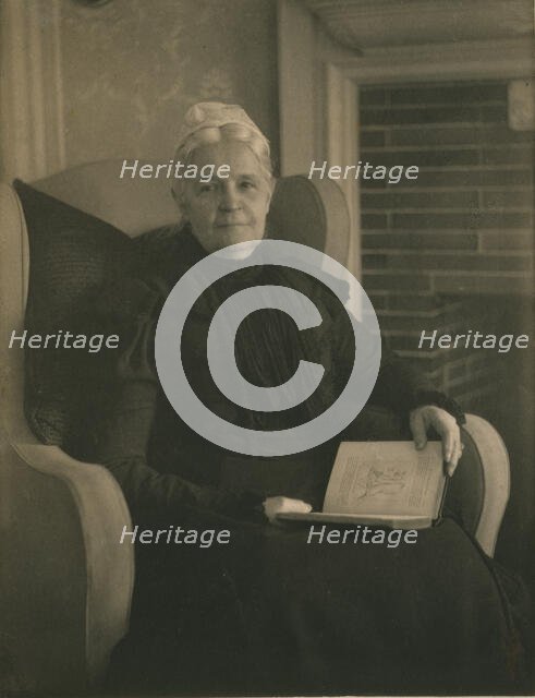 Old woman in an armchair, with an open book in her lap, c1900. Creator: Mathilde Weil.