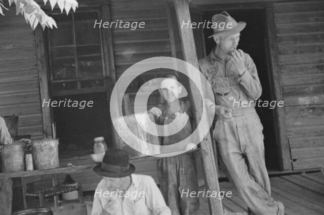 Bud Fields, Tengle boy, and Floyd Burroughs on Frank Tengle's porch, Hale County, Alabama, 1936. Creator: Walker Evans.