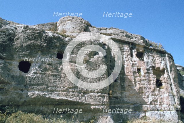 Assyrian rock reliefs pitted by Chr hermit caves, Bavian, Iraq, 1977.