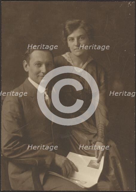 Portrait of a Man and a Woman Holding Magazine, 1907-1943. Creator: Louis Fleckenstein.