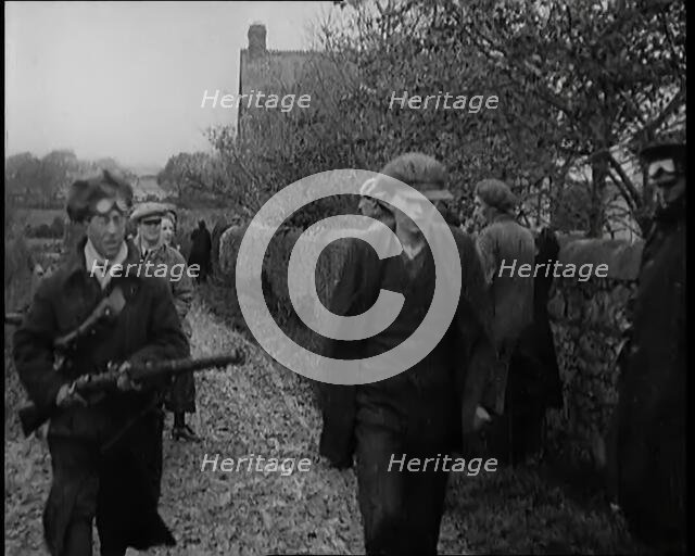 Male Civilian Being Arrested and Escorted Along a Country Lane by a Police Officer, 1920s. Creator: British Pathe Ltd.