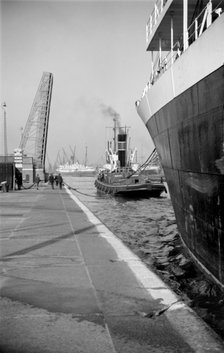 A ship being towed into the King George V Dock, Canning Town, London, c1945-c1965.  Artist: SW Rawlings