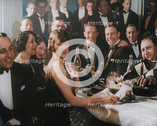 A Group of Fashionable Young People Sitting at a Table Drinking Champagne, 1924. Creator: British Pathe Ltd.