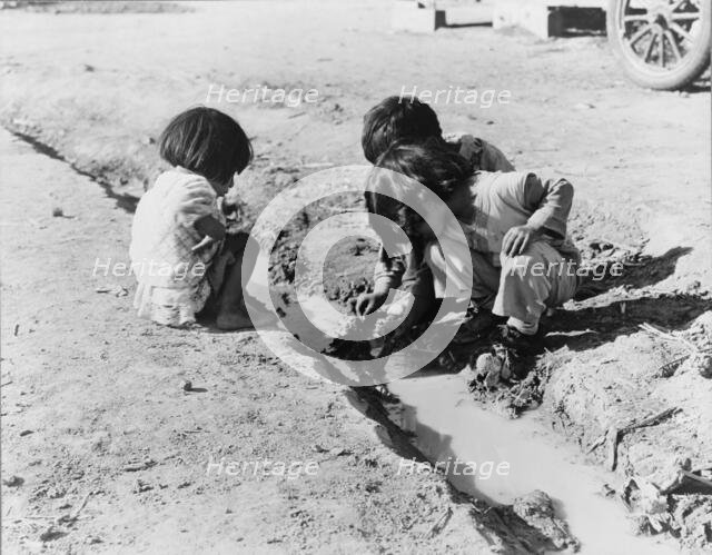 Mexican children playing in ditch, near Corcoran, California, 1936. Creator: Dorothea Lange.