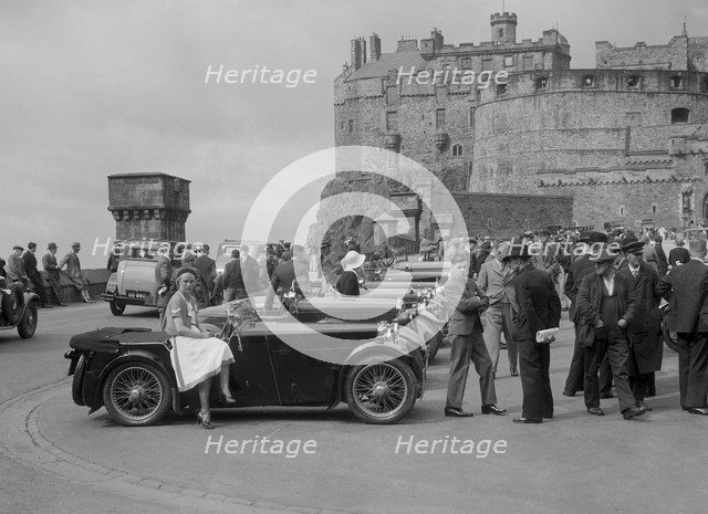 Kitty Brunell and her MG Magna on Castle Esplanade, Edinburgh, RSAC Scottish Rally, 1932. Artist: Bill Brunell.
