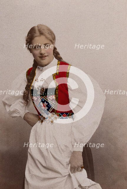 A young Norwegian woman, posing in a photographic studio wearing peasant dress, 1901. Creator: Sostrene Persen.