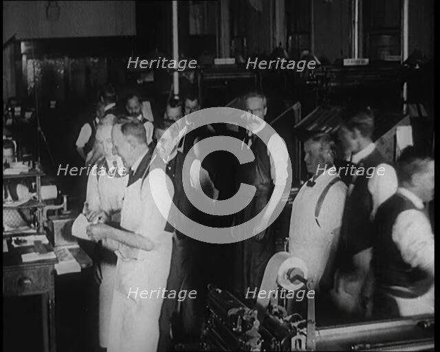 Male Screen Printers Working in a News Room, Using Various Pieces of Printing Machinery, 1921. Creator: British Pathe Ltd.