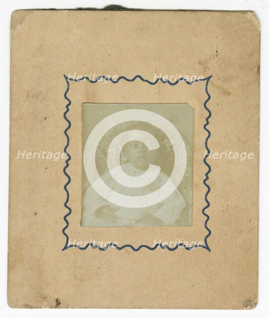 Photograph of a baby dressed in white and sitting in a chair, ca. 1870. Creator: Unknown.