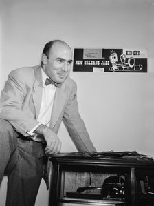 Portrait of George Avakian in his office or home, New York, N.Y.(?), 1938. Creator: William Paul Gottlieb.