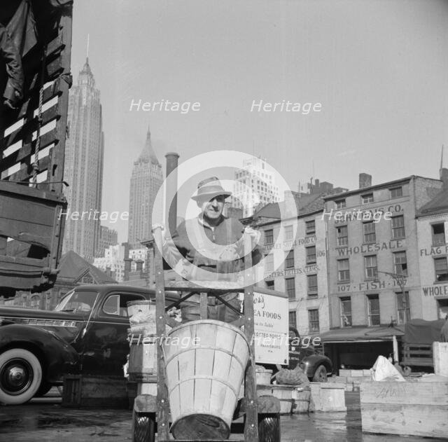 Stevedore who packs and loads crates of fish on the lower east side, 1943. Creator: Gordon Parks.