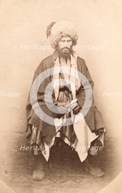 Full-length portrait of man, seated, facing front, between 1870 and 1886. Creator: Unknown.