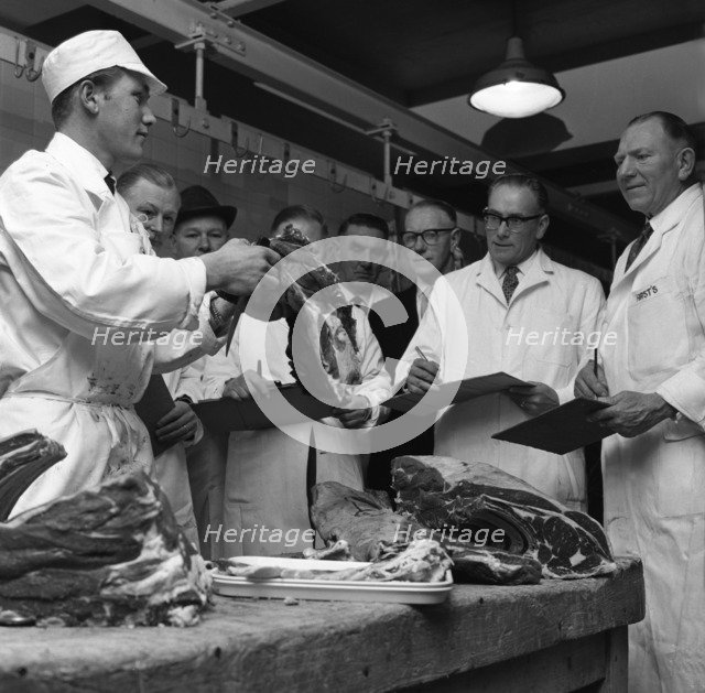 Apprentice butcher showing his work to competition judges, Barnsley, South Yorkshire, 1963. Artist: Michael Walters